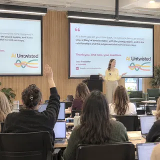 Jess presenting to a room of attendees at an AI Untwisted workshop